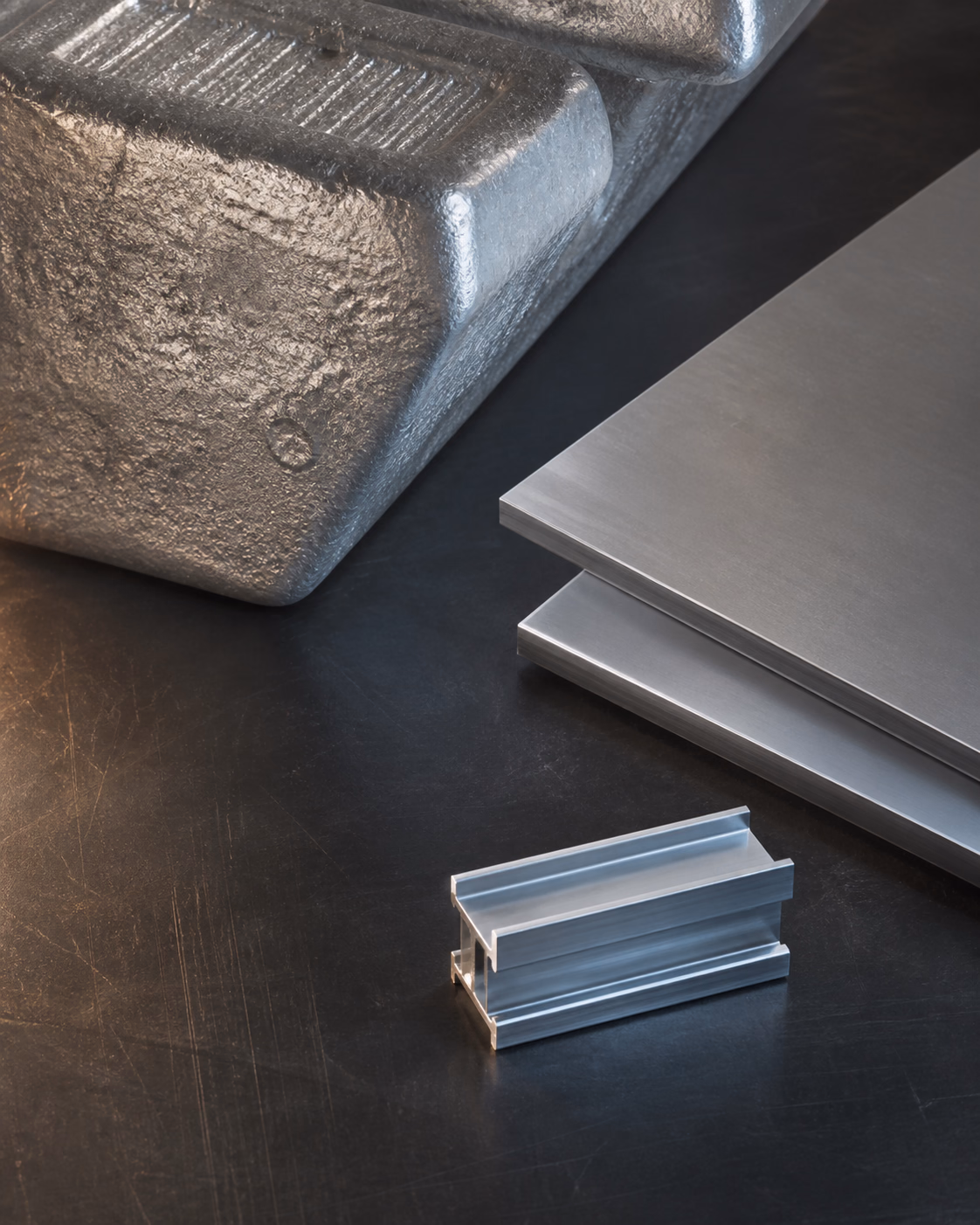 Aluminium ingots and sheet coils in a logistics warehouse